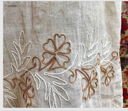 embroidered linens with flowers and leaves on them