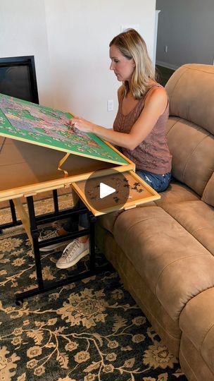 a woman is sitting on the couch with a large piece of furniture in front of her