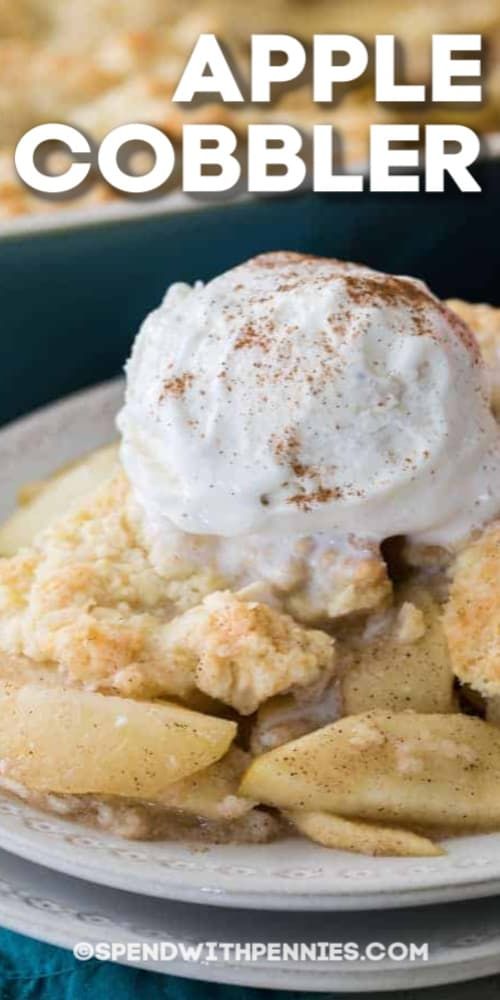 an apple cobbler on a plate with whipped cream and apples in the foreground