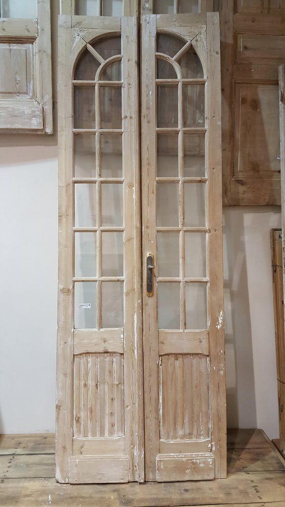 the interior french doors are made from wood and have glass inserts on each side