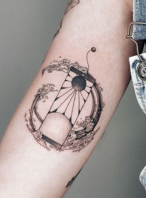 a woman's arm with a tattoo on it and an object in the middle