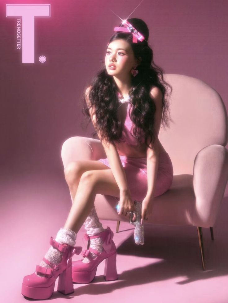 a woman in pink is sitting on a chair with her legs crossed and wearing high heels