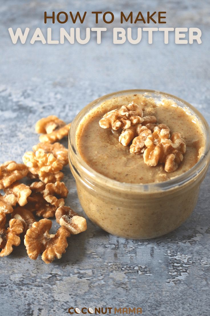 walnut butter in a small glass jar with nuts scattered around it