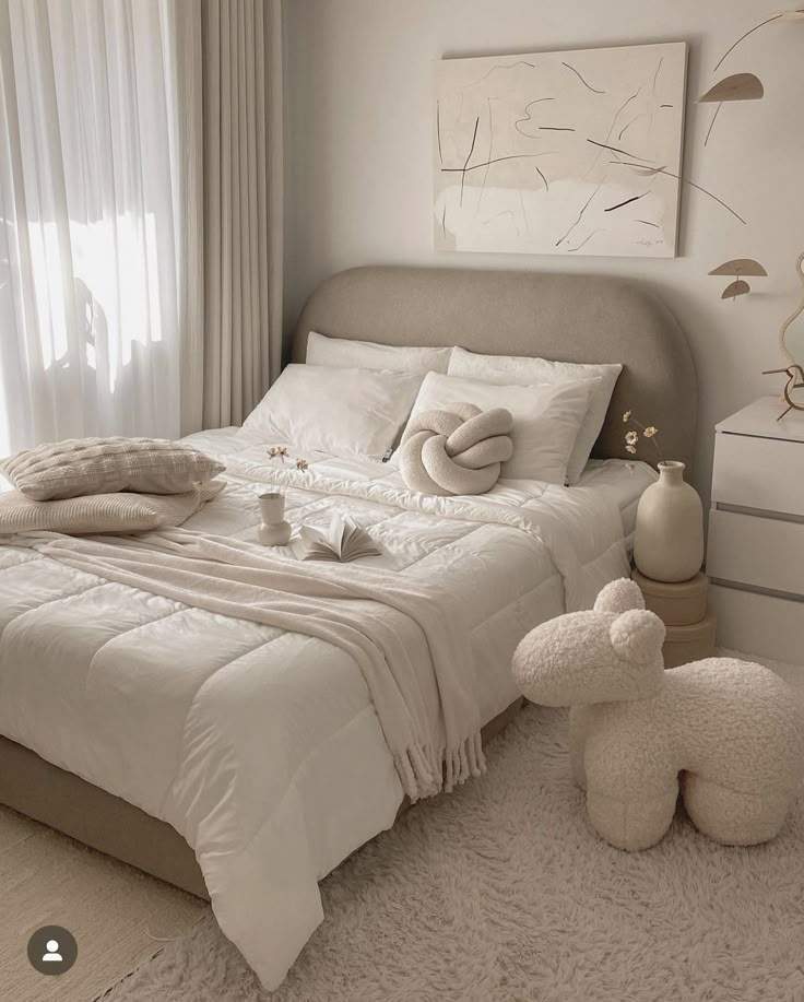 a bed with white sheets and pillows in a bedroom next to two teddy bears on the floor