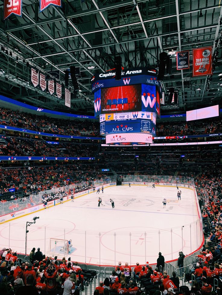 an ice hockey arena with fans watching the game