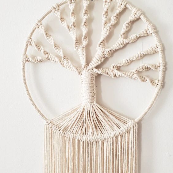 a white wall hanging with a tree on it