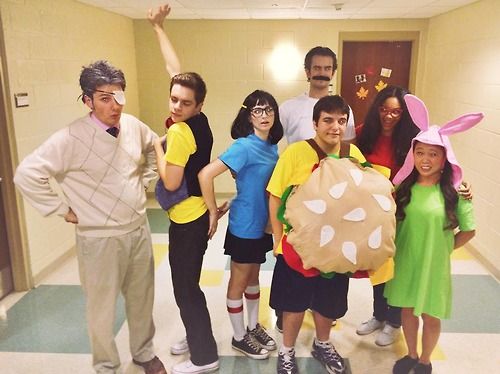 a group of people in costumes posing for a photo with an easter bunny costume on