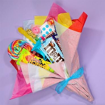 a colorful paper bag filled with candy and candies