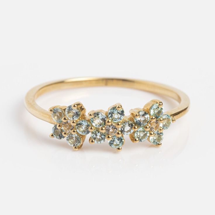 Flower Aquamarine Half Eternity Ring, Statement flower ring, 14k Gold Floral Wedding Band For Women, Unique Flower ring, Birthstone Ring   Main Stone: Aquamarine  Main Stone Color: Blue Main Stone Shape: Round Secondary Stone: Diamond Secondary Stone Shape: Round S I L V E R J E W E L R Y C A R E Silver is not the best friend of oxygen and sulfur; it can be oxidized and tarnished from time to time it is the nature of silver. To keep the silver shiny and prevent it from oxidizing fast, we would recommend the following instructions; * Avoid any chemical agents including perfume, makeup, and hair spray. * Avoid wearing silver jewelry to the beach, shower, or exercise. * Remove before you sleep, clean it with a silver cloth, and keep it in a dry area or a small zip-lock package. G E M S T O N Floral Wedding Band, Floral Wedding Bands, Wedding Band For Women, Trio Ring, Local Eclectic, London Blue Topaz Ring, Fancy Gifts, Ring Birthstone, Wedding Anniversary Rings