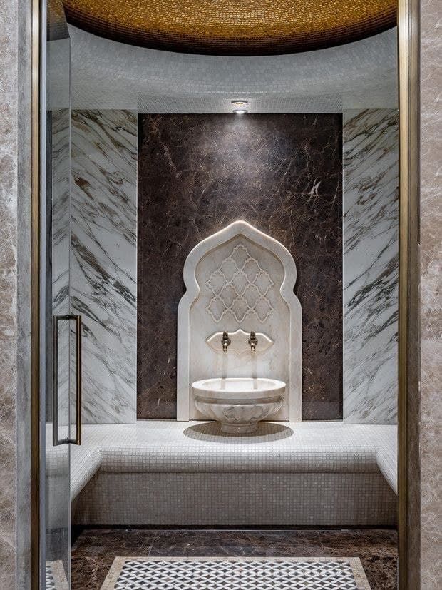 a fancy bathroom with marble walls and flooring