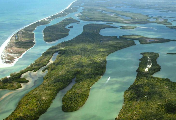 an aerial view of the ocean and landforms in the middle of the island area