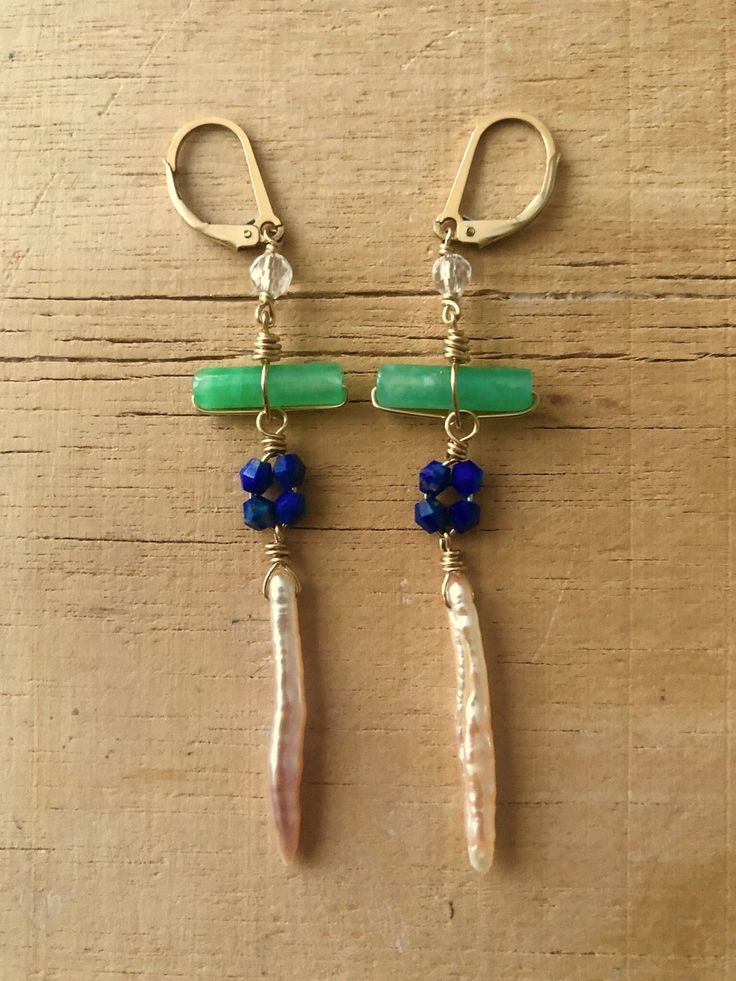 Beautiful long earrings with selected stones and pearl, wrapped with 14/20 yellow gold wire. The stones for these earrings are quartz, green jade, lapis and pearl. Ther close with a 14/20 gild filled lever back ear wire.  These long earrings are great for summer and make a lerfect gift for women that like colorful earrings with gold. They are light weight and have a nice movement. Green Wire Wrapped Long Drop Earrings, Wire Wrapped Dangle Earrings For May Birthstone, Green Bohemian 14k Gold Filled Earrings, Green Wire Wrapped Long Drop Jewelry, Elegant Wire Wrapped Earrings For May Birthstone, Green Dangle Pearl Earrings With Ear Wire, Pmc Earrings, Earrings Stones, Sundance Jewelry