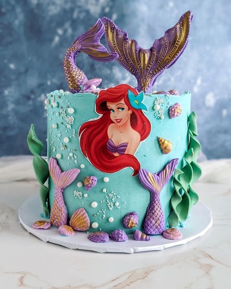 the little mermaid cake is decorated with fondant