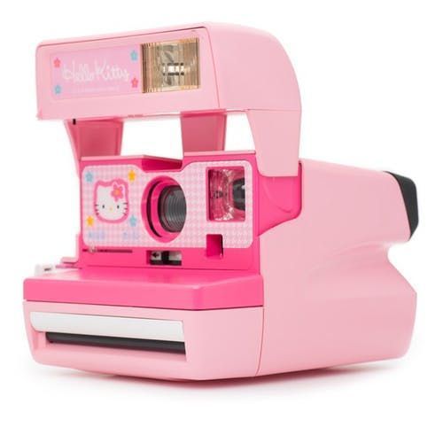 a pink polaroid camera with hello kitty on it