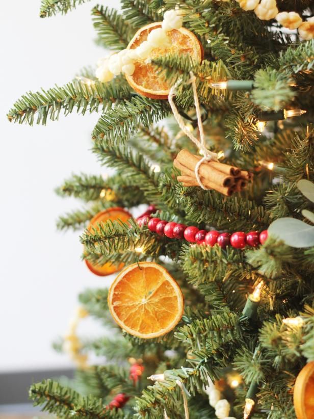 the christmas tree is decorated with oranges and spices