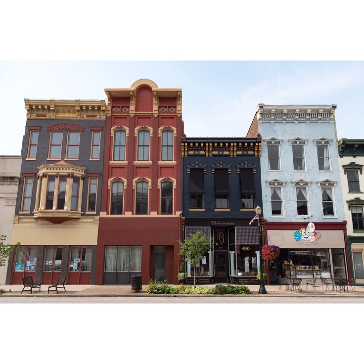 several different colored buildings line the street in front of each other