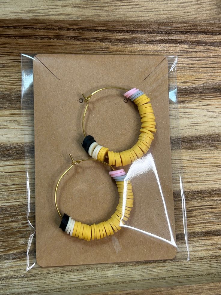 The perfect gift for your favorite teacher.✏️📚 Trendy Handmade Hoop Jewelry, Trendy Adjustable Dangle Hoop Earrings, Trendy Handmade Small Hoop Earrings, Gift Single Hoop Earring, Retro Small Hoop Earrings For Gifts, Small Hoop Handmade Earrings As Gift, Trendy Multicolor Hoop Earrings As Gift, Trendy Yellow Hoop Earrings As Gift, Trendy Yellow Hoop Earrings For Gift