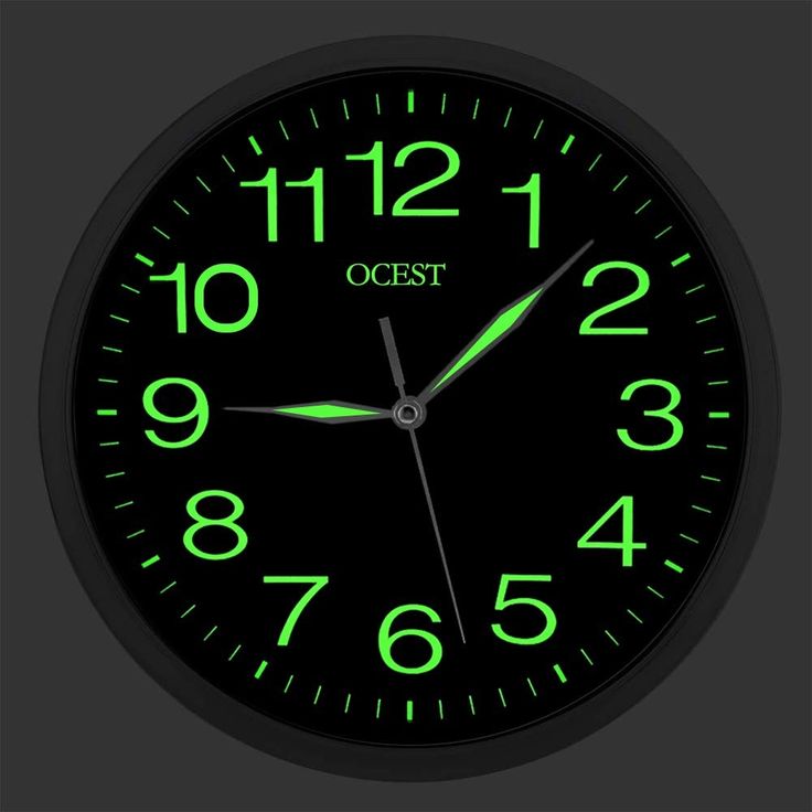 a black clock with green numbers and the words ocst on it's face