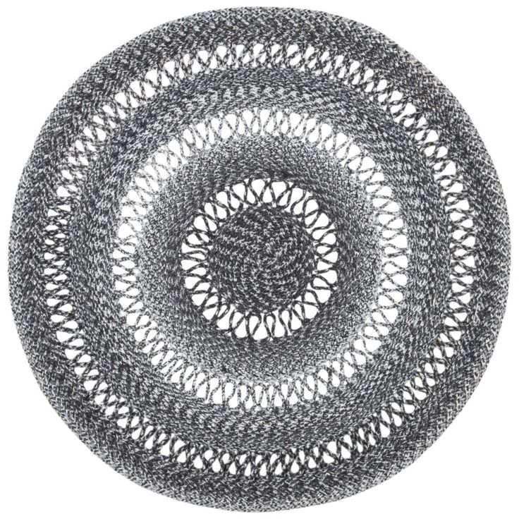 a circular rug made out of black and white crocheted yarn on a white background