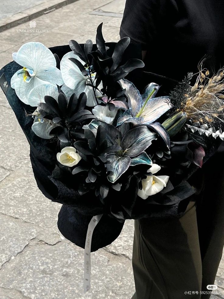 a woman holding a bouquet of flowers on the street