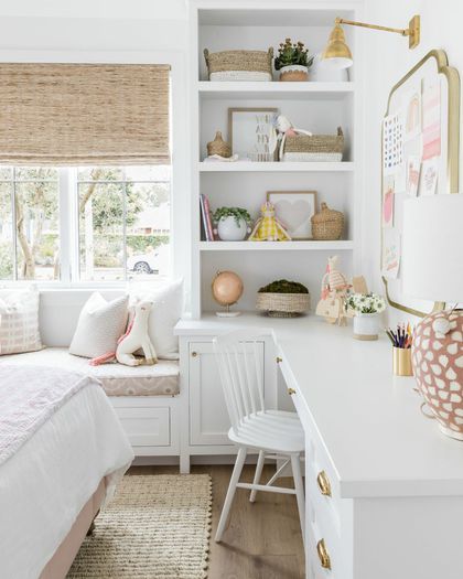 a white bedroom with lots of shelves and furniture