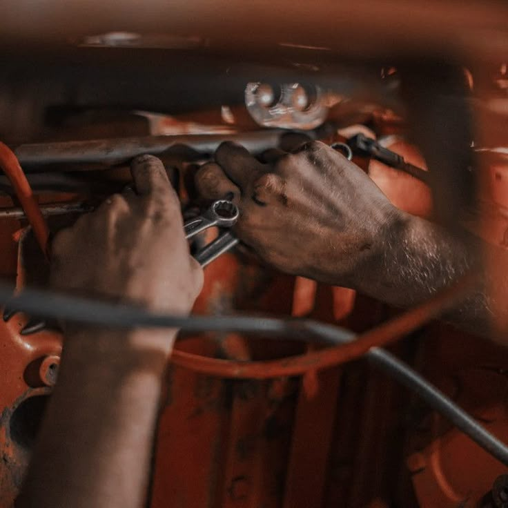 a man working on an engine in a car