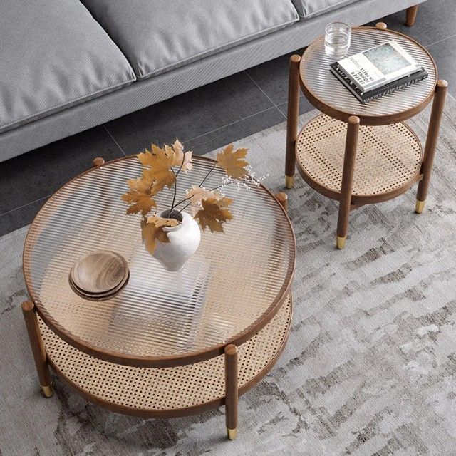 two tables sitting on top of a rug next to a couch