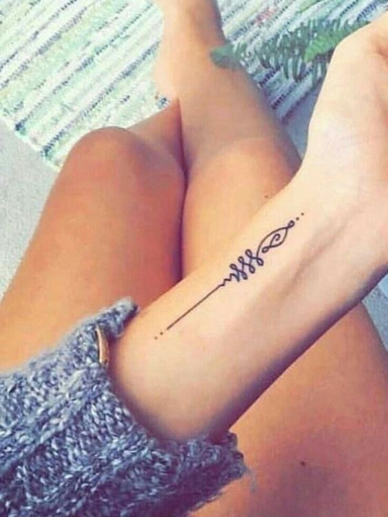 a woman's arm with a tattoo on it and the word w is written in cursive writing