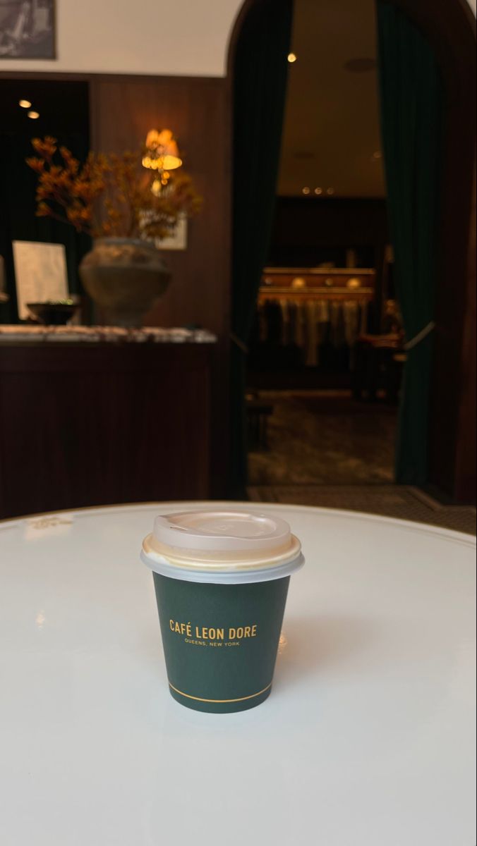 a coffee cup sitting on top of a white table