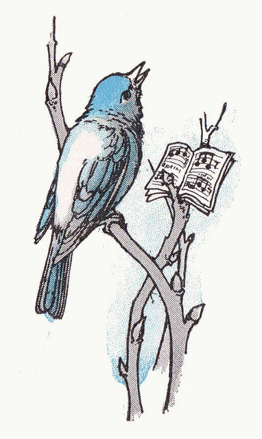 a blue bird sitting on top of a tree branch with an open book in it's beak