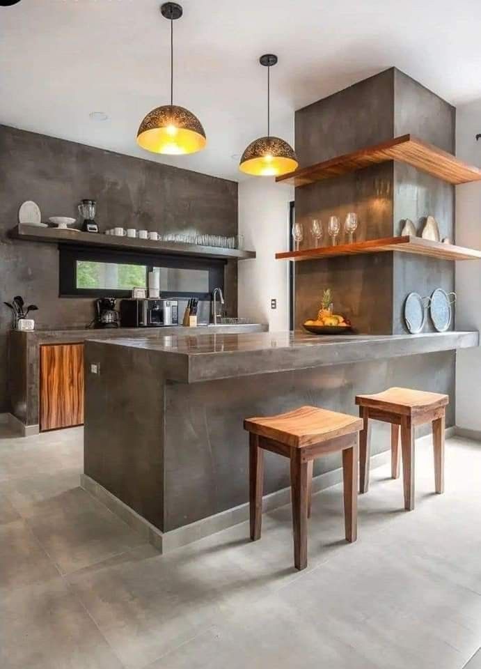 a modern kitchen with two stools in the center