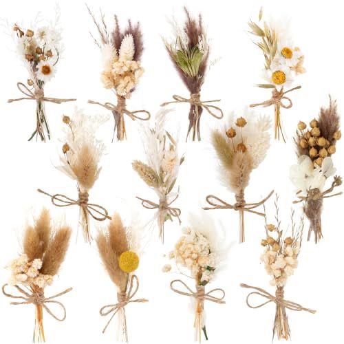 an assortment of dried flowers tied together with twine and burlap ribbons on a white background