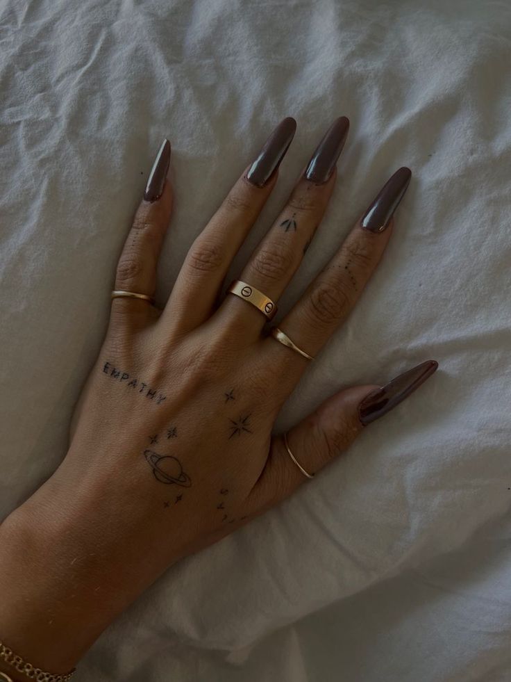 a woman's hand with two rings on it