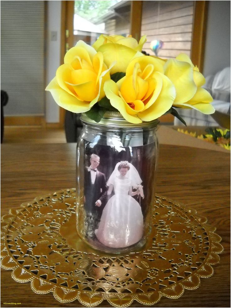 yellow roses in a mason jar on a doily with an image of a bride and groom