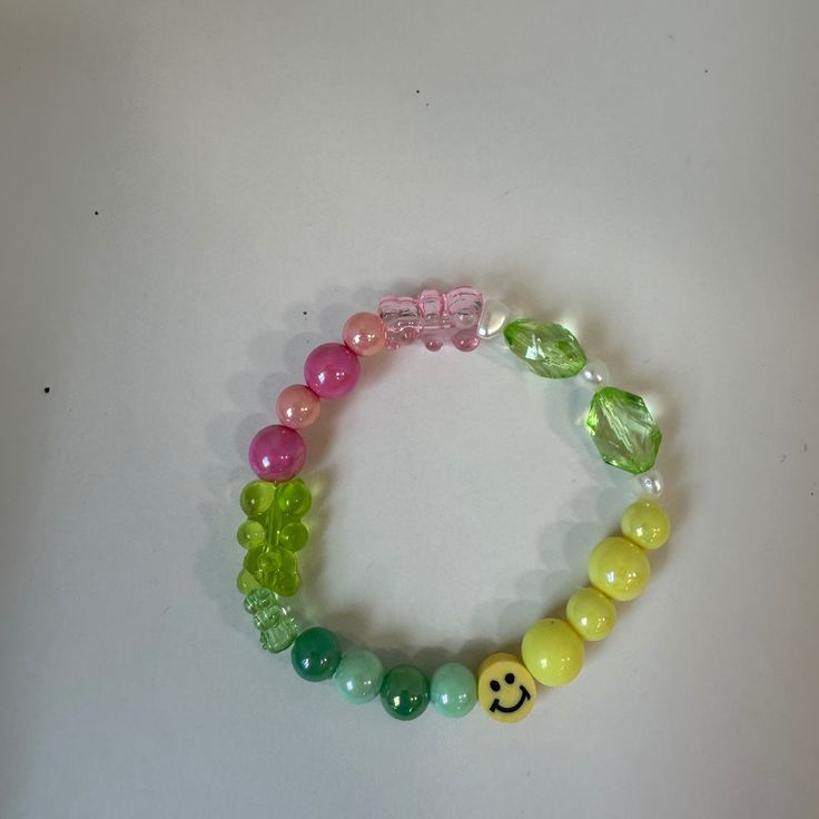 This Is A Super Cute Wacky Bracelet. This Is Multicolored And Has A Clay Smiley Face Bead On It. There Are Also Some Gummy Bears On This Bracelet As Well. This Bracelet Is Super Cute And Would Be Great To Wear Every Day. Bundles And Reasonable Offers Welcome! Wacky, Cute, Y2k, Smiley Face, Clay Beads, Shiny Beads, Unique, Adorable, Maximalist, Multicolored, Colorful, Casual, Every Day, 90's, 90's Theme, Gummy Bears, Gummy, Cutesy, Girly, Feminine, Girlhoodcore, Girlhood Core, Kiddy Wacky Jewelry, Trendy Customized Pink Bracelet, Customized Pink Trendy Beaded Bracelets, Trendy Customized Pink Bracelets, Fun Customized Pink Bracelets, Casual Customized Green Jewelry, Funky Pink Bracelets As A Gift, Pink Rave Beaded Bracelets For Gift, Funky Pink Beaded Jewelry