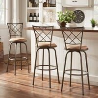 three stools in front of a kitchen bar with white cabinets and wood flooring