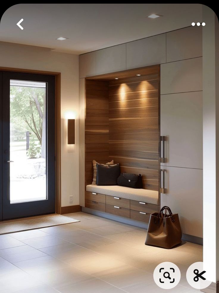 a modern entry way with wooden paneling and lighting