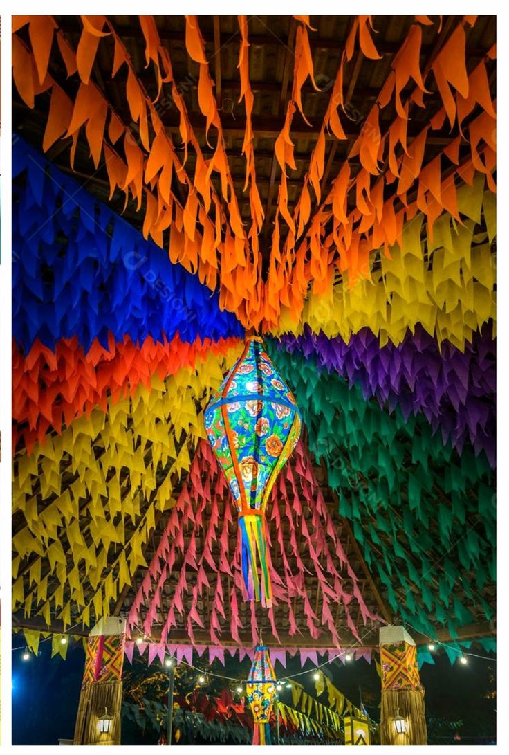 colorful paper cranes hanging from the ceiling at an event