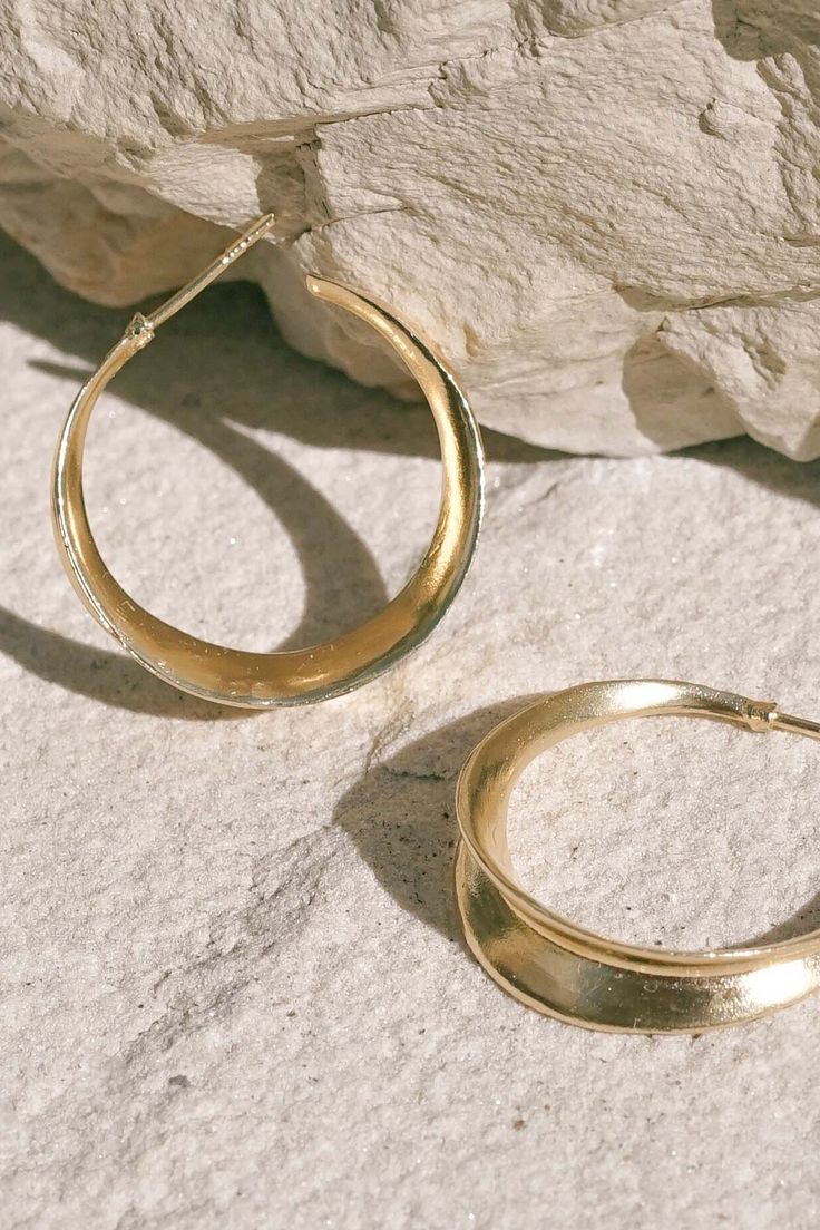 From our friends at Mountainside: Carved minimal inverted light weight hoop stud earrings. A unique take on a classic style. Earrings are available in recycled brass coated in a thick layer of high grade 14k gold. Includes silicone earring backs which we’ve found to be most comfortable and secure and best suited to this style of earring. Made in the U.S.A. CARE: Most metals will naturally patina over time, however, there are measures you can take to prolong the life of your jewelry. We recommend Gift Recycled Gold Tarnish Resistant Hoop Earrings, Gift Tarnish Resistant Recycled Gold Hoop Earrings, Gift Recycled Gold Tarnish-resistant Hoop Earrings, Hand Forged Bronze Small Hoop Jewelry, Gold Open Circle Sterling Silver Earrings, Gold Sterling Silver Open Circle Earrings, Timeless Brass Hoop Earrings, Gold Crescent Hoop Earrings For Everyday, Gold Crescent Hoop Earrings With Hammered Detail