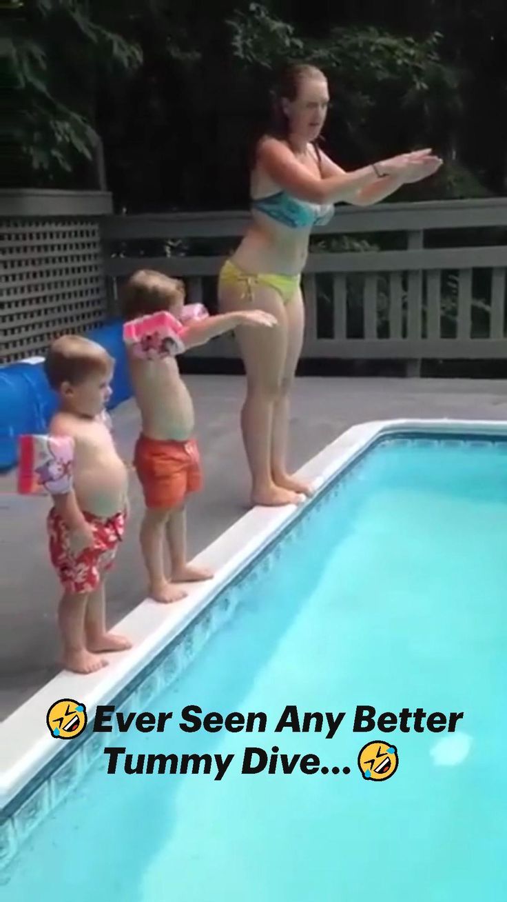 three children standing on the edge of a swimming pool