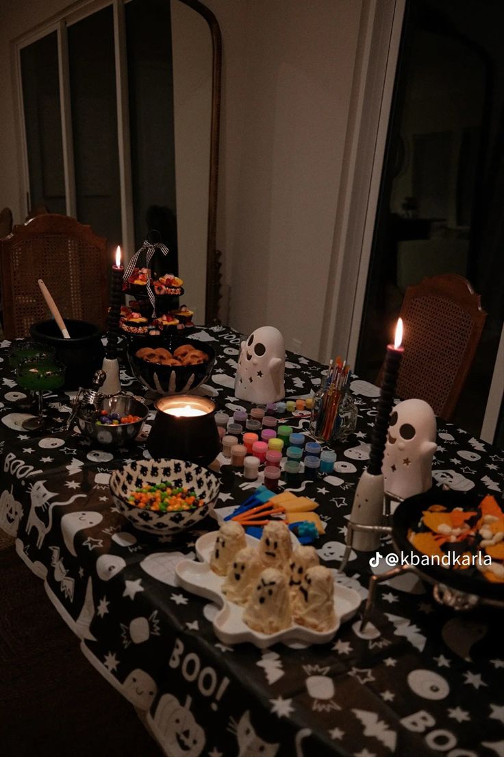 a table topped with lots of halloween food