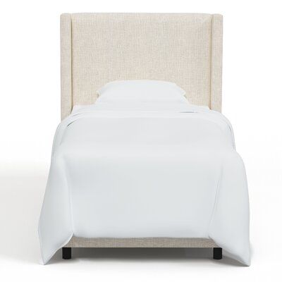 a bed with white linens and pillows on top of it, in front of a white background