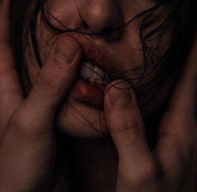 a woman with her hands on her face