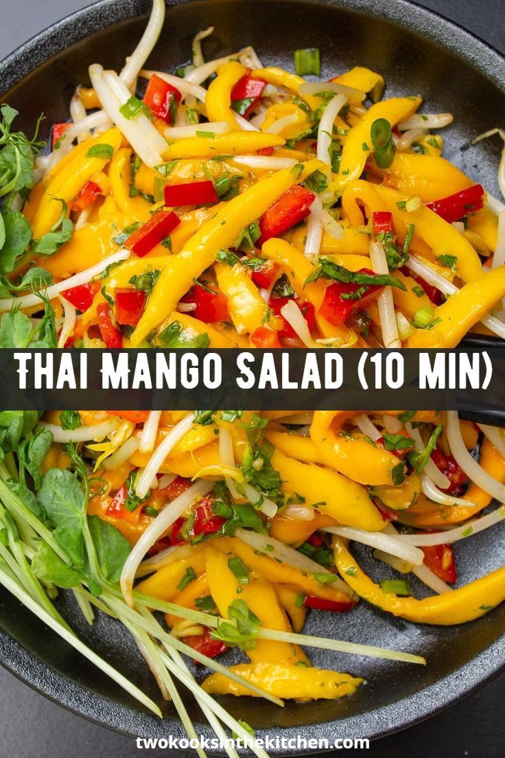 a pan filled with vegetables and greens on top of a table