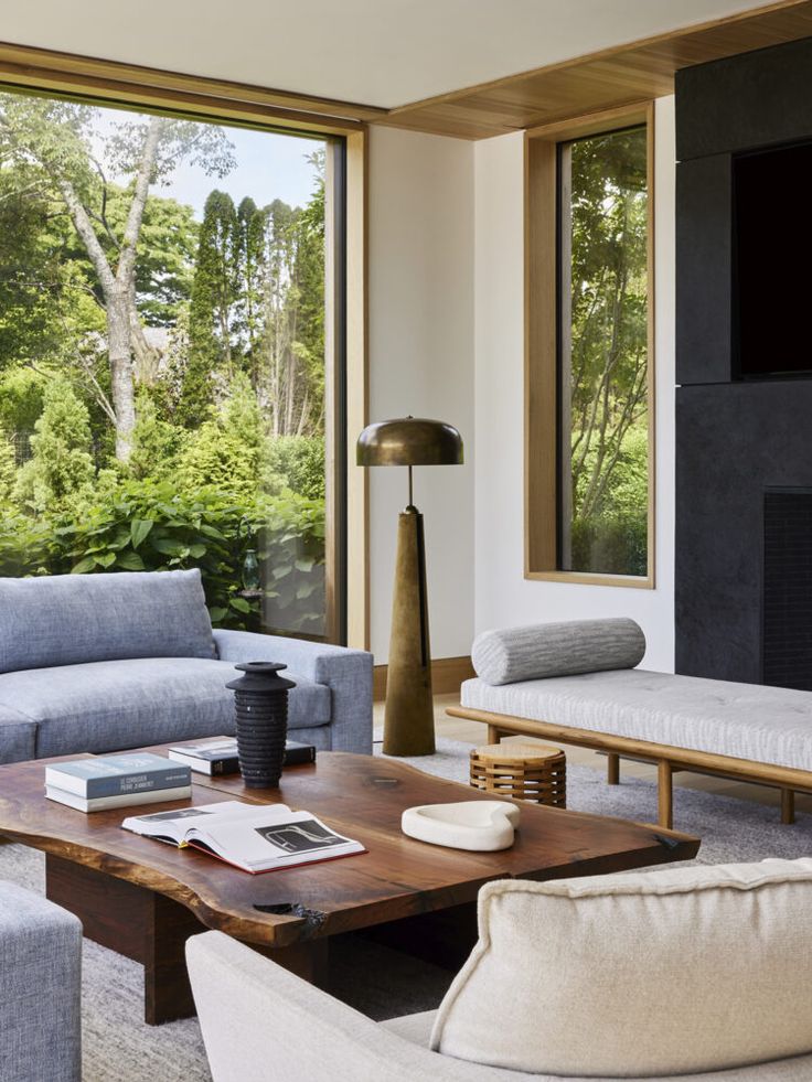 a living room filled with furniture and large windows