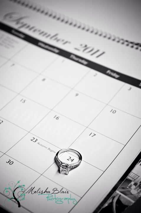 a wedding ring sitting on top of a calendar