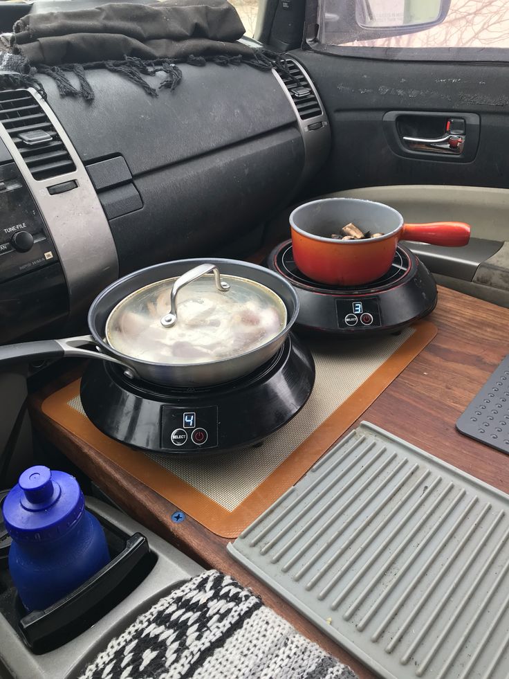 the interior of a car with various items in it including pots, pans and other kitchen utensils