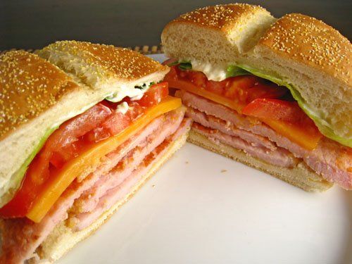 a cut in half sandwich sitting on top of a white plate