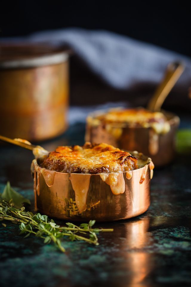 some food that is sitting on top of a metal pan with spoons in it