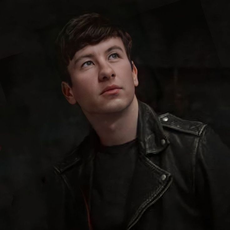 a young man in a black leather jacket looks up at the sky with his eyes wide open